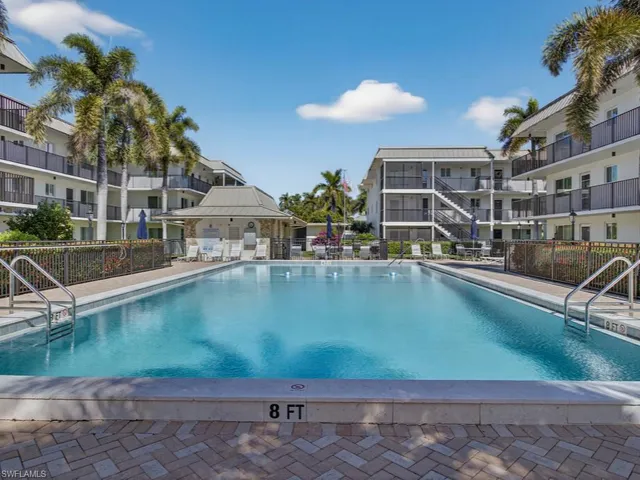 a view of a swimming pool with a garden and patio