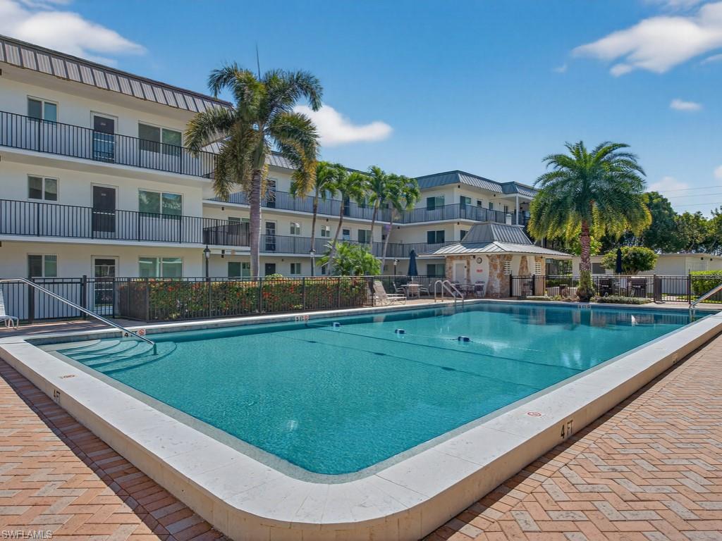 766 Central Avenue, Unit 101 Naples, FL 34102 - Photo 18 of 19 a view of a swimming pool with a garden and patio
