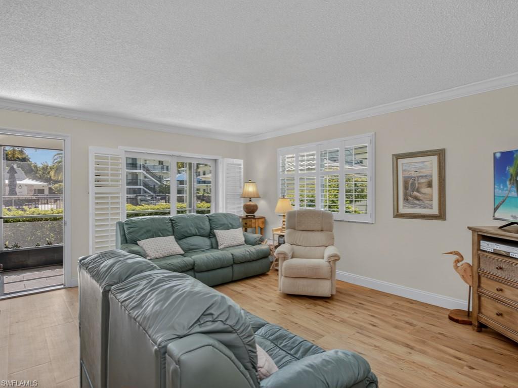 766 Central Avenue, Unit 101 Naples, FL 34102 - Photo 3 of 19 a living room with furniture and a window