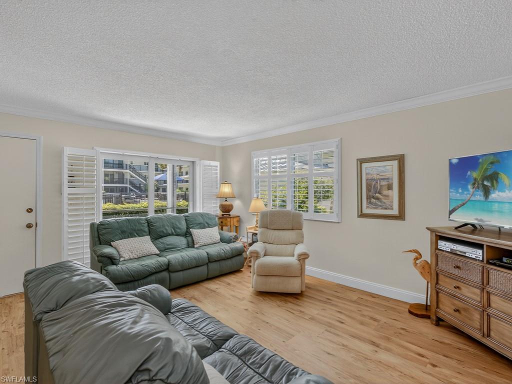 766 Central Avenue, Unit 101 Naples, FL 34102 - Photo 4 of 19 a living room with furniture and a window