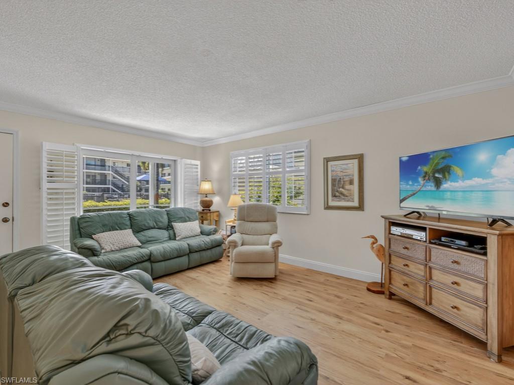 766 Central Avenue, Unit 101 Naples, FL 34102 - Photo 5 of 19 a living room with furniture and a window