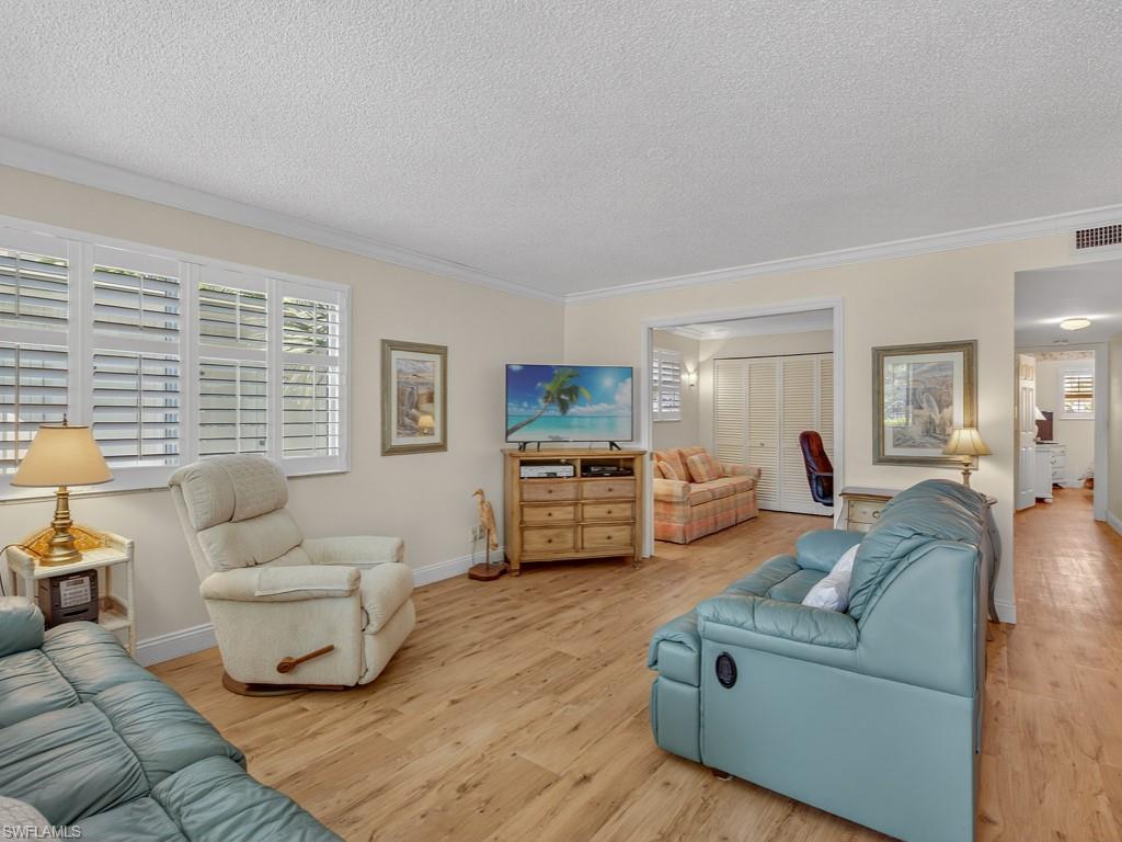 766 Central Avenue, Unit 101 Naples, FL 34102 - Photo 6 of 19 a living room with furniture and a couch