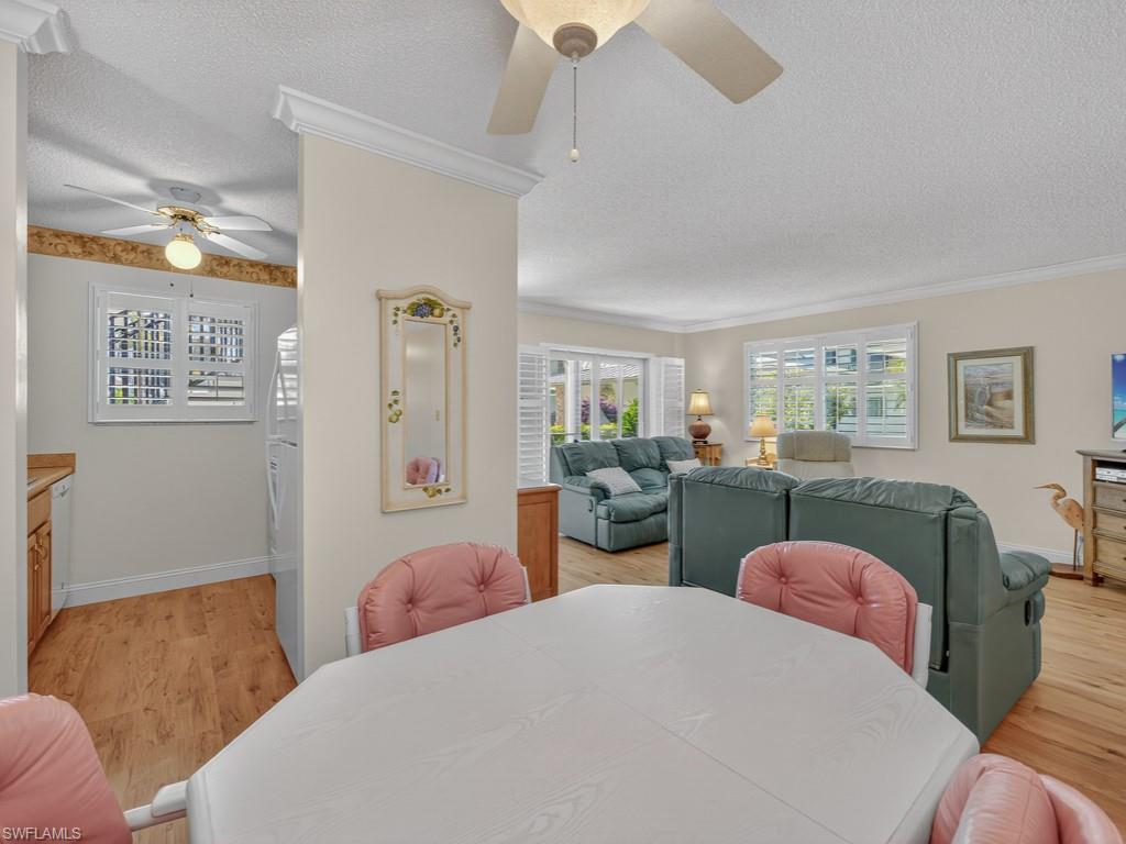 766 Central Avenue, Unit 101 Naples, FL 34102 - Photo 9 of 19 a bedroom with two beds and a desk