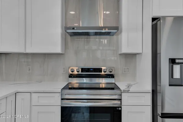 a stove top oven sitting inside of a kitchen