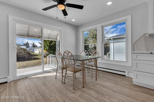 a view of a dining room with furniture window and wooden floor