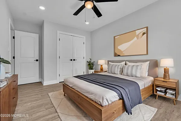 a spacious bedroom with a bed and a chandelier