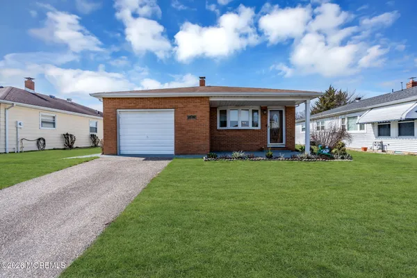 a front view of house with yard and green space