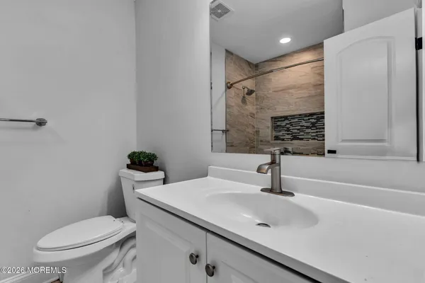 a bathroom with a sink toilet and shower