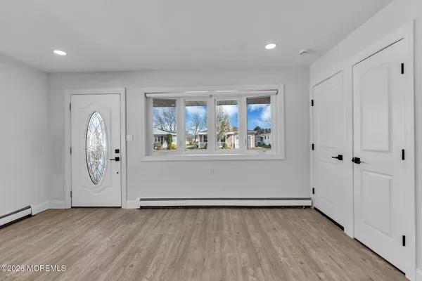 a view of a room with wooden floor and window