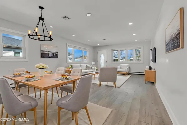 a view of a dining room with furniture and wooden floor