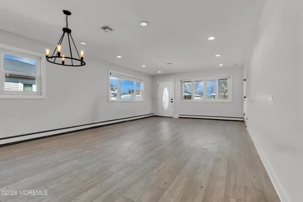 a view of a livingroom with wooden floor and window