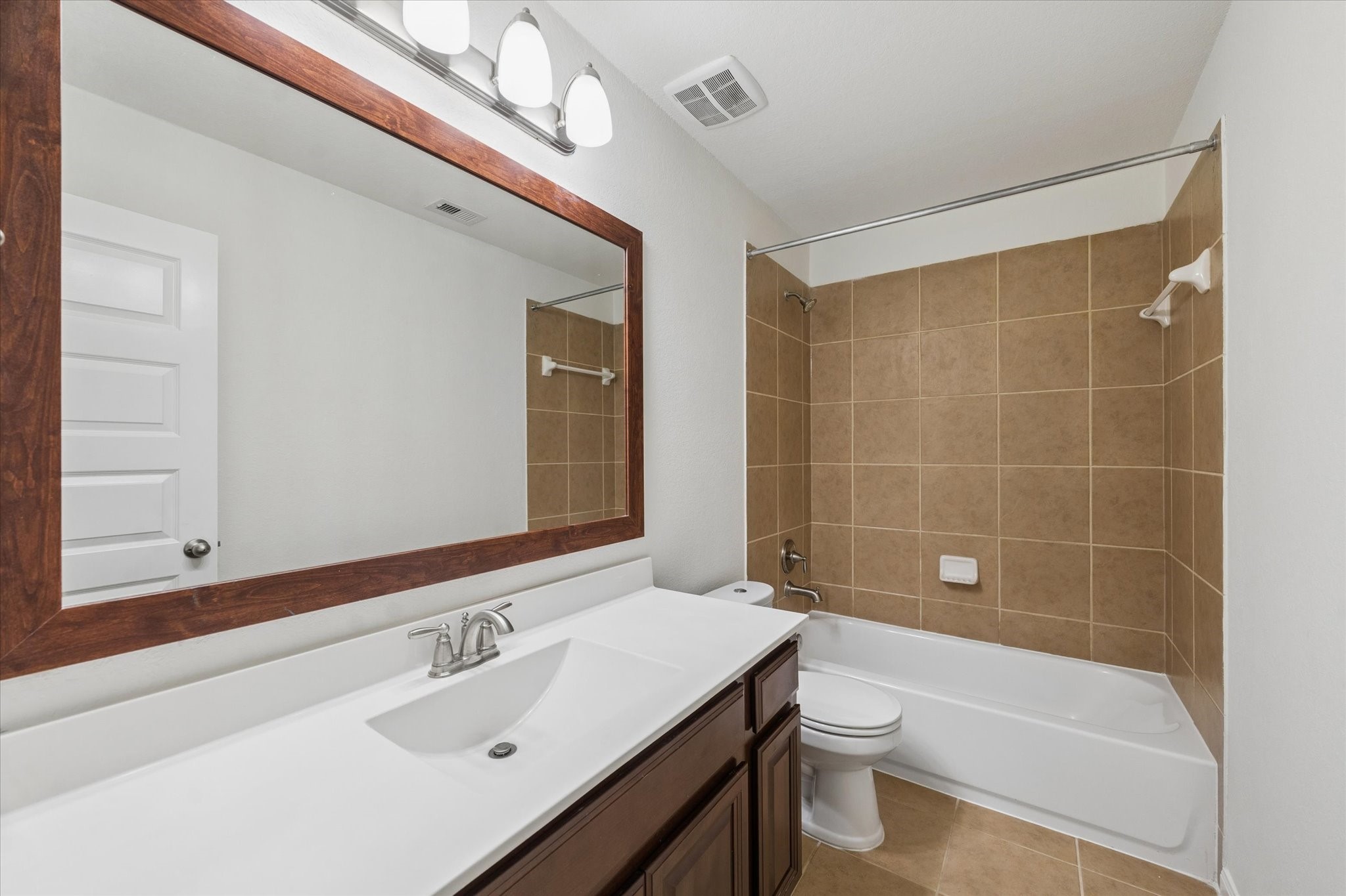 7015 Riata Hills Lane Spring, TX 77379 - Photo 26 of 33 This spacious secondary bathroom offers ample counter space and well-designed cabinetry for optimal storage, presenting a clean, move-in ready feel.