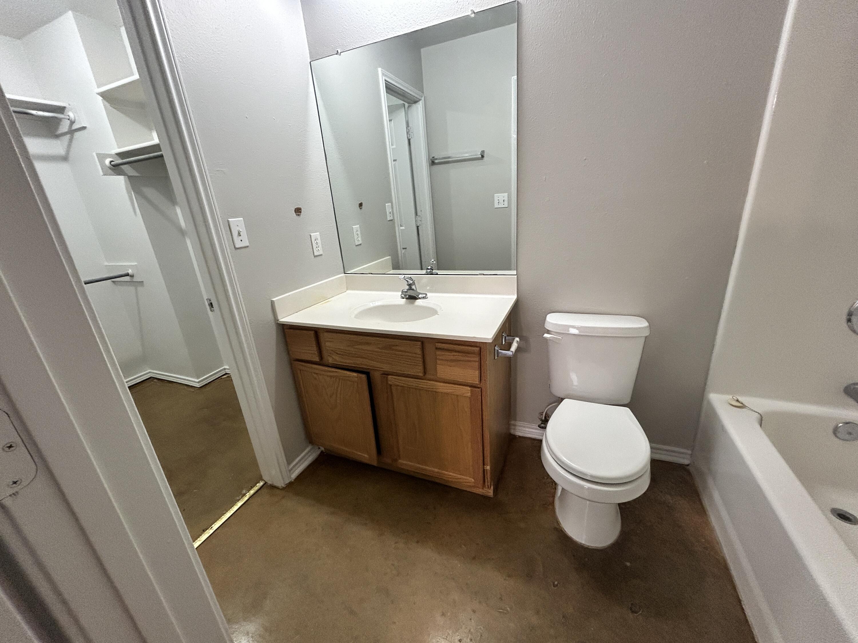 1106 82nd Street, Unit B Lubbock, TX 79423 - Photo 8 of 8 a bathroom with a sink toilet and shower