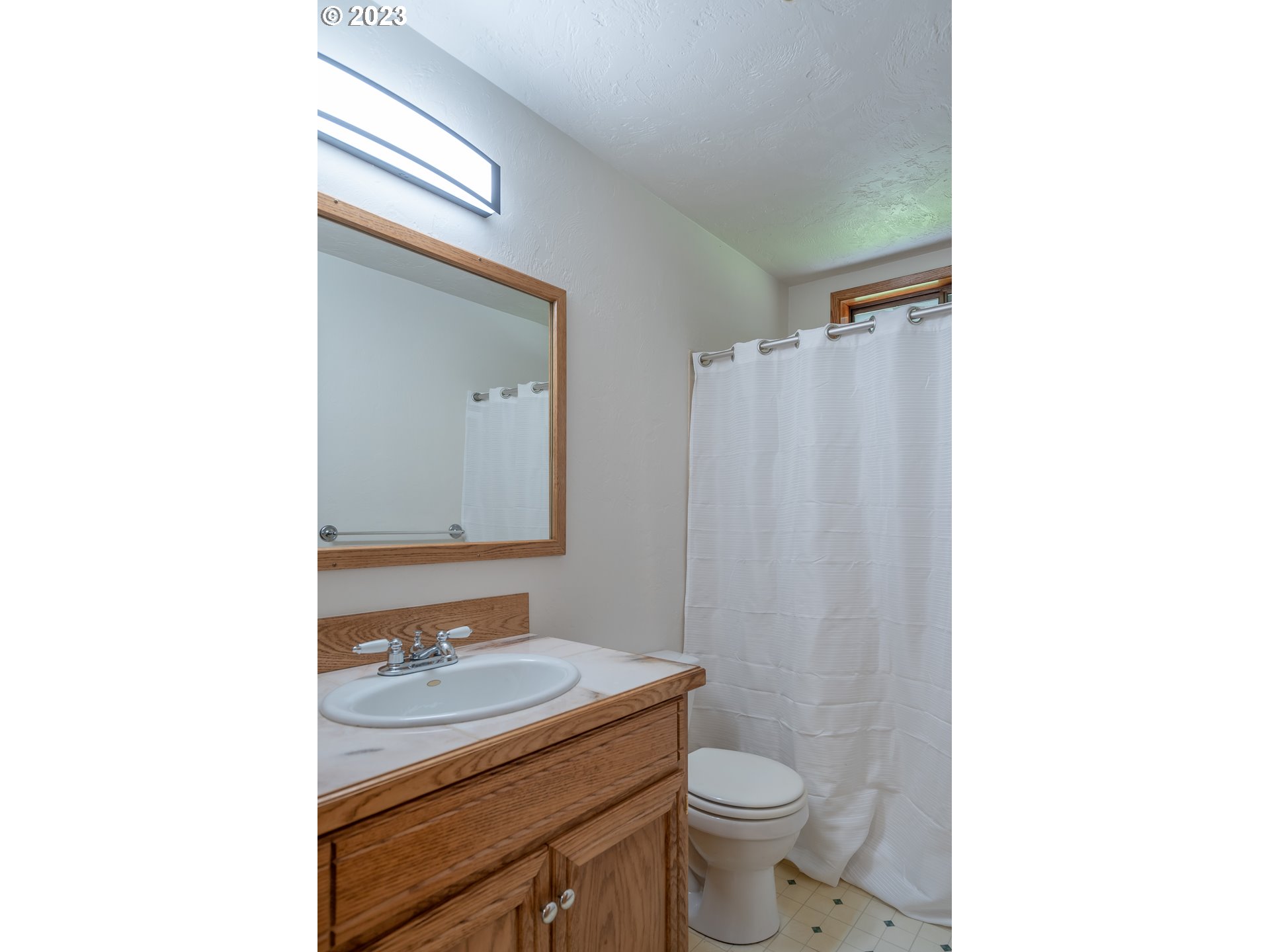 7441 A Street Springfield, OR 97478 - Photo 19 of 25 a bathroom with a granite countertop sink toilet and mirror
