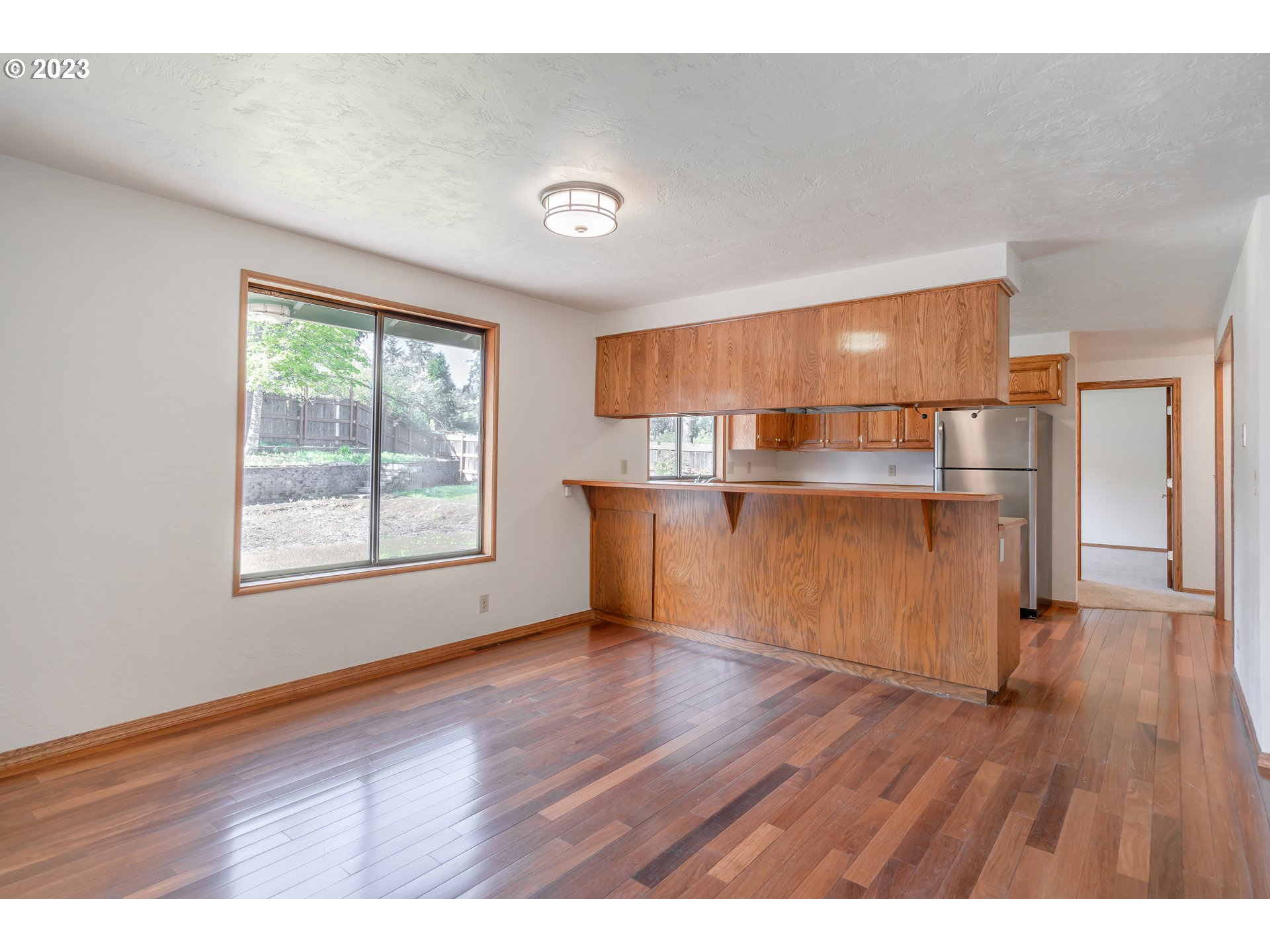 7441 A Street Springfield, OR 97478 - Photo 3 of 25 a view of a kitchen with wooden floor electronic appliances and window