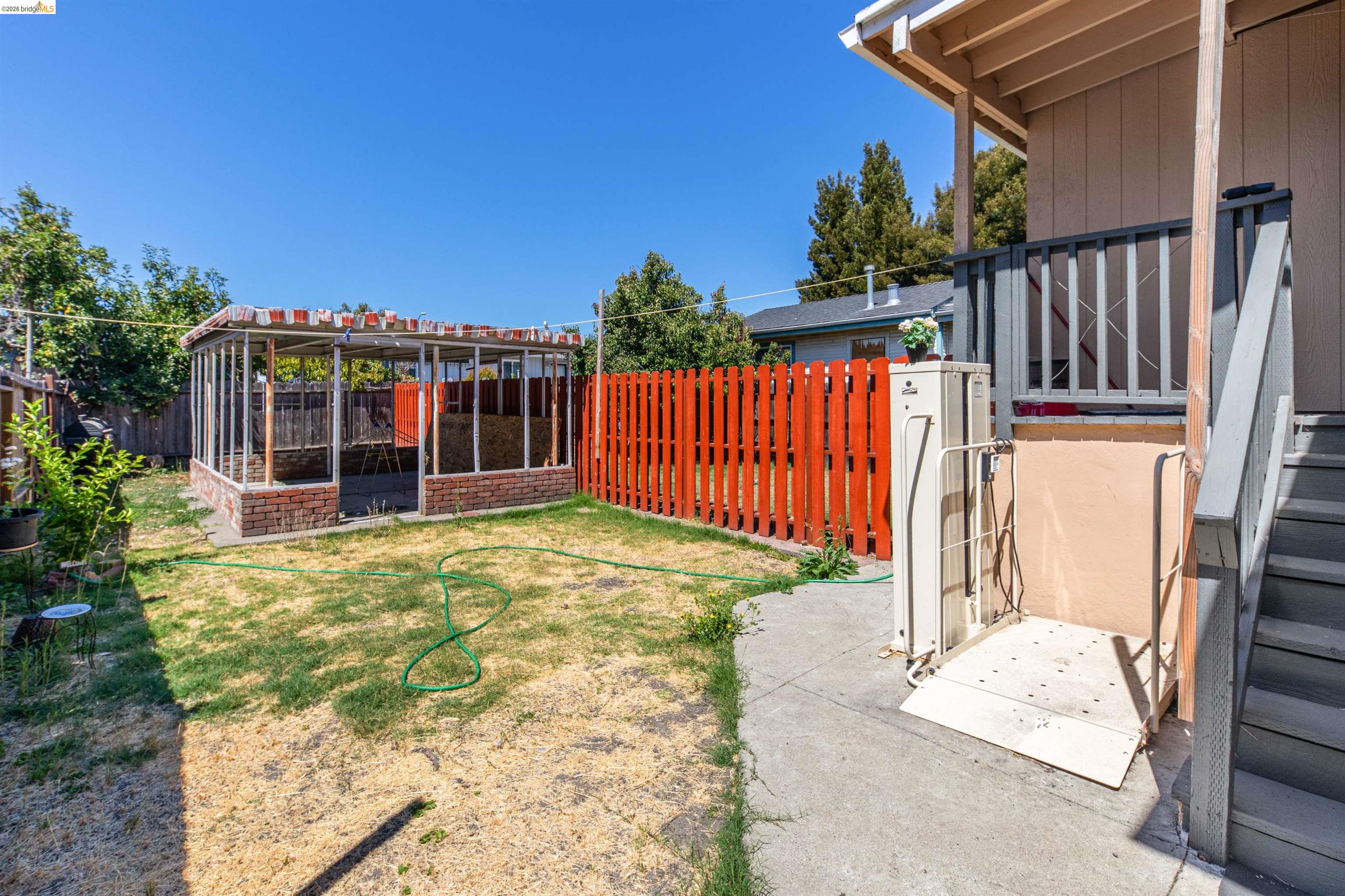 1821 74th Avenue Oakland, CA 94621 - Photo 11 of 27 Fenced backyard with a patio area