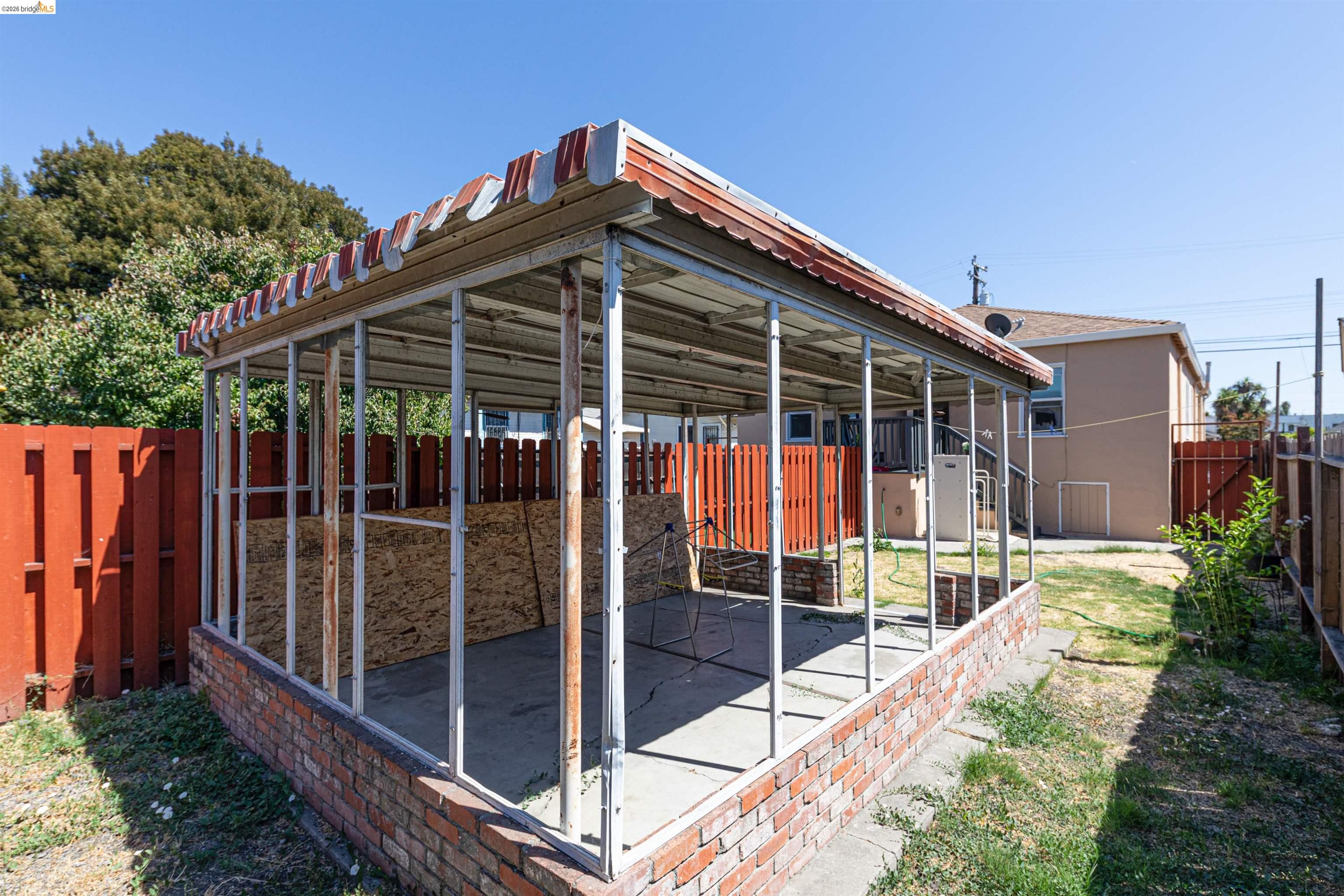 1821 74th Avenue Oakland, CA 94621 - Photo 13 of 27 View of home's exterior with a patio and a fenced backyard