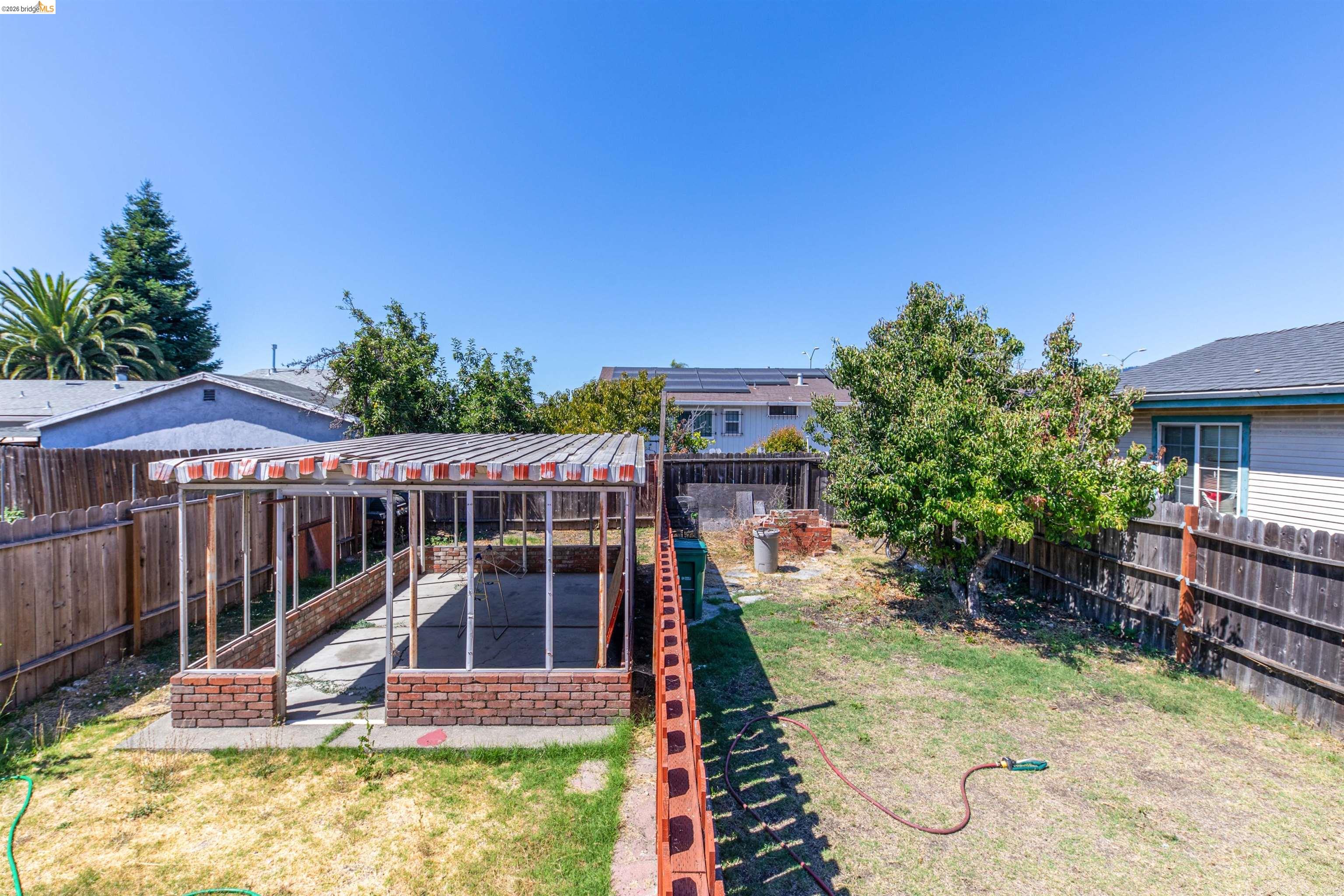 1821 74th Avenue Oakland, CA 94621 - Photo 14 of 27 Fenced backyard featuring a patio and a pergola
