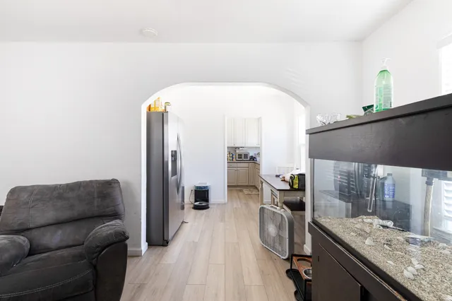 a view of a house with wooden fence next to a yard