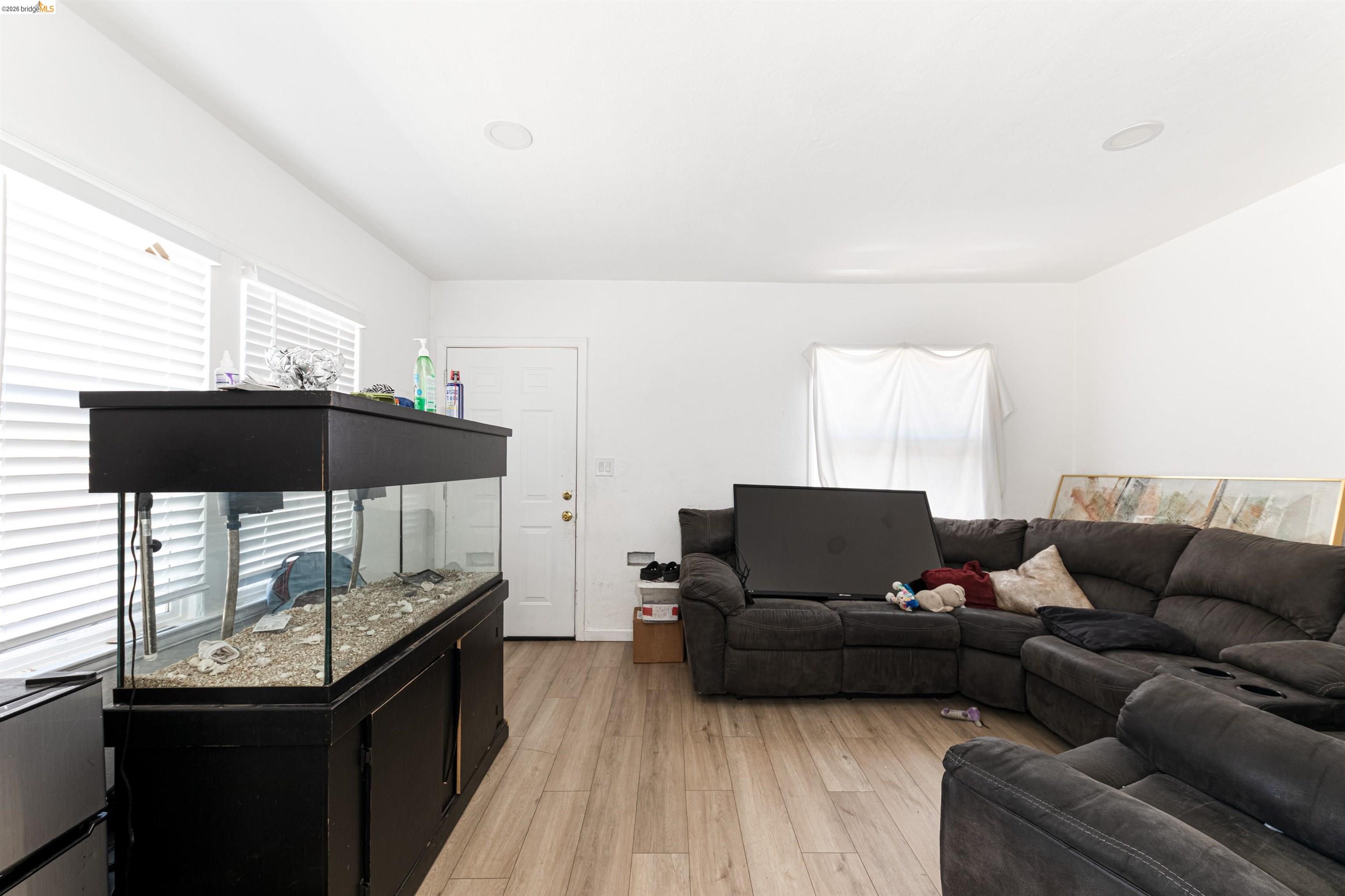 1821 74th Avenue Oakland, CA 94621 - Photo 17 of 27 Living room with light wood-style flooring