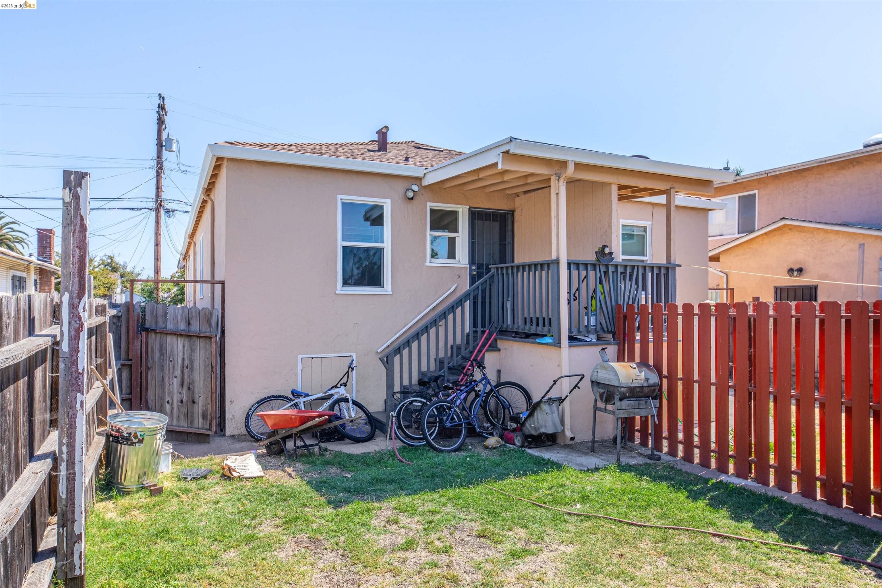 1821 74th Avenue Oakland, CA 94621 - Photo 24 of 27 Rear view of house with a patio area and stucco siding