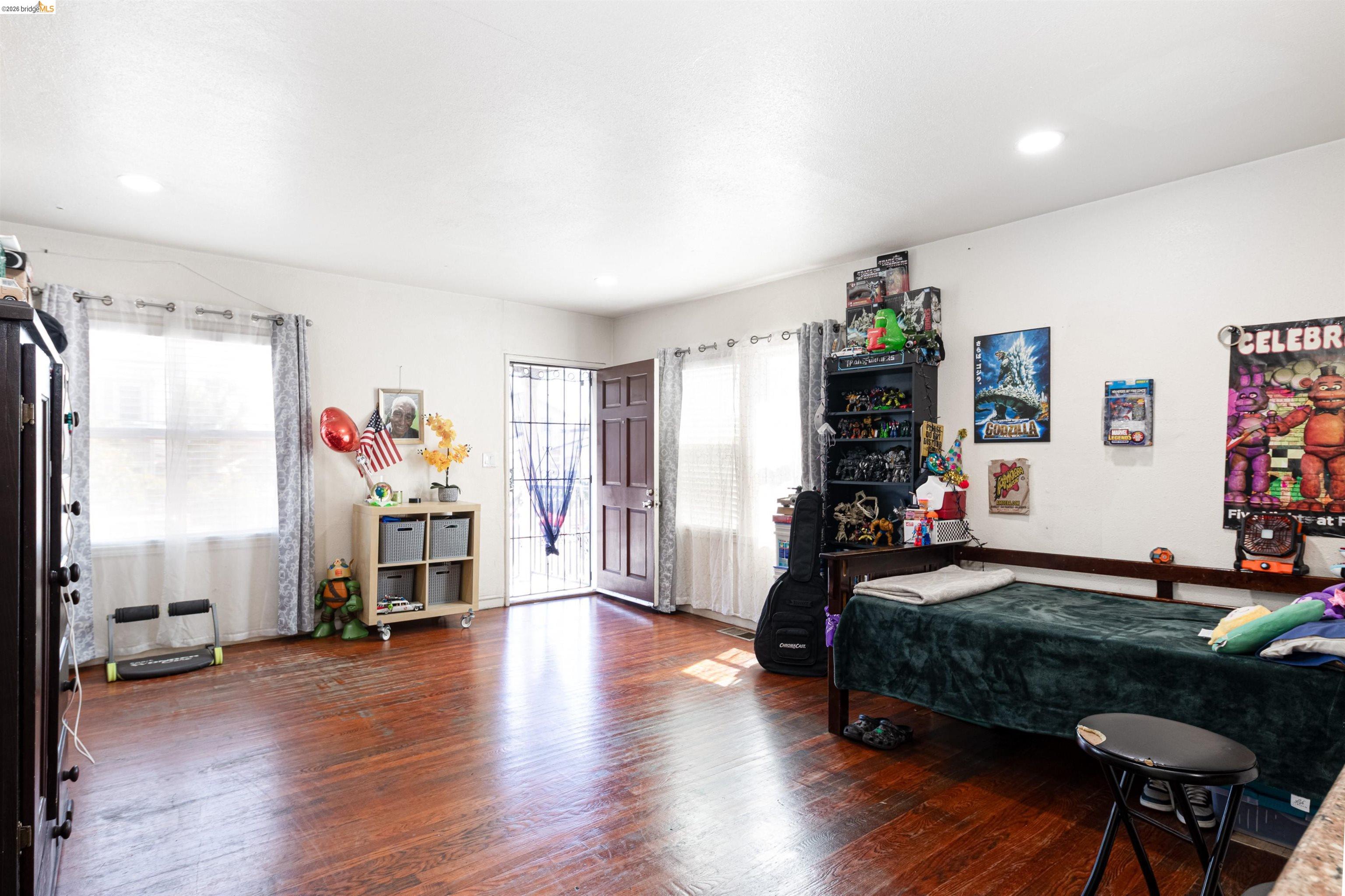 1821 74th Avenue Oakland, CA 94621 - Photo 6 of 27 Bedroom featuring wood finished floors and recessed lighting