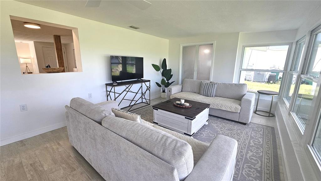 1210 Maryknoll Road Englewood, FL 34223 - Photo 17 of 37 a living room with furniture and a flat screen tv