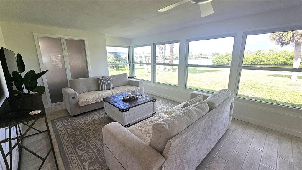 1210 Maryknoll Road Englewood, FL 34223 - Photo 21 of 37 a living room with furniture and a large window