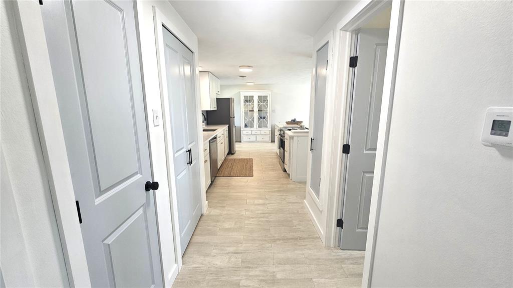 1210 Maryknoll Road Englewood, FL 34223 - Photo 25 of 37 a view of a hallway with a livingroom and a bathroom with sink