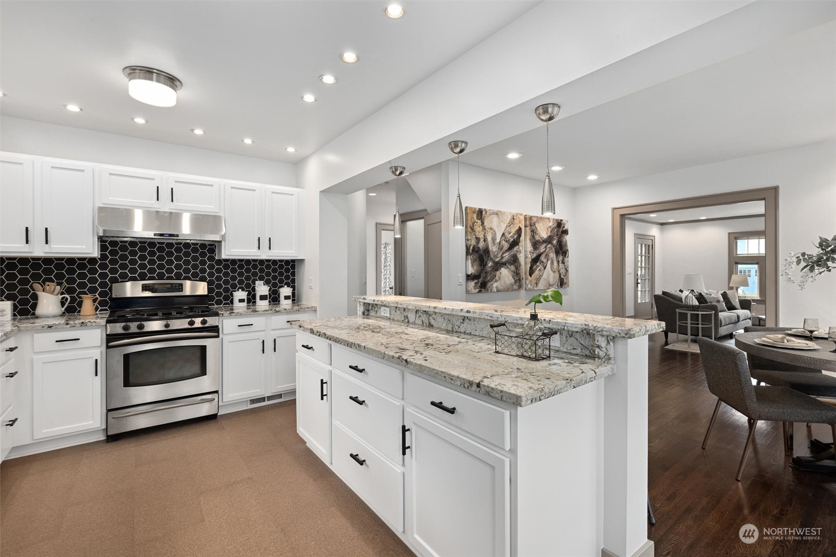 5916 8th Avenue Northeast Seattle, WA 98105 - Photo 16 of 40 a kitchen with stainless steel appliances kitchen island granite countertop a stove and a sink