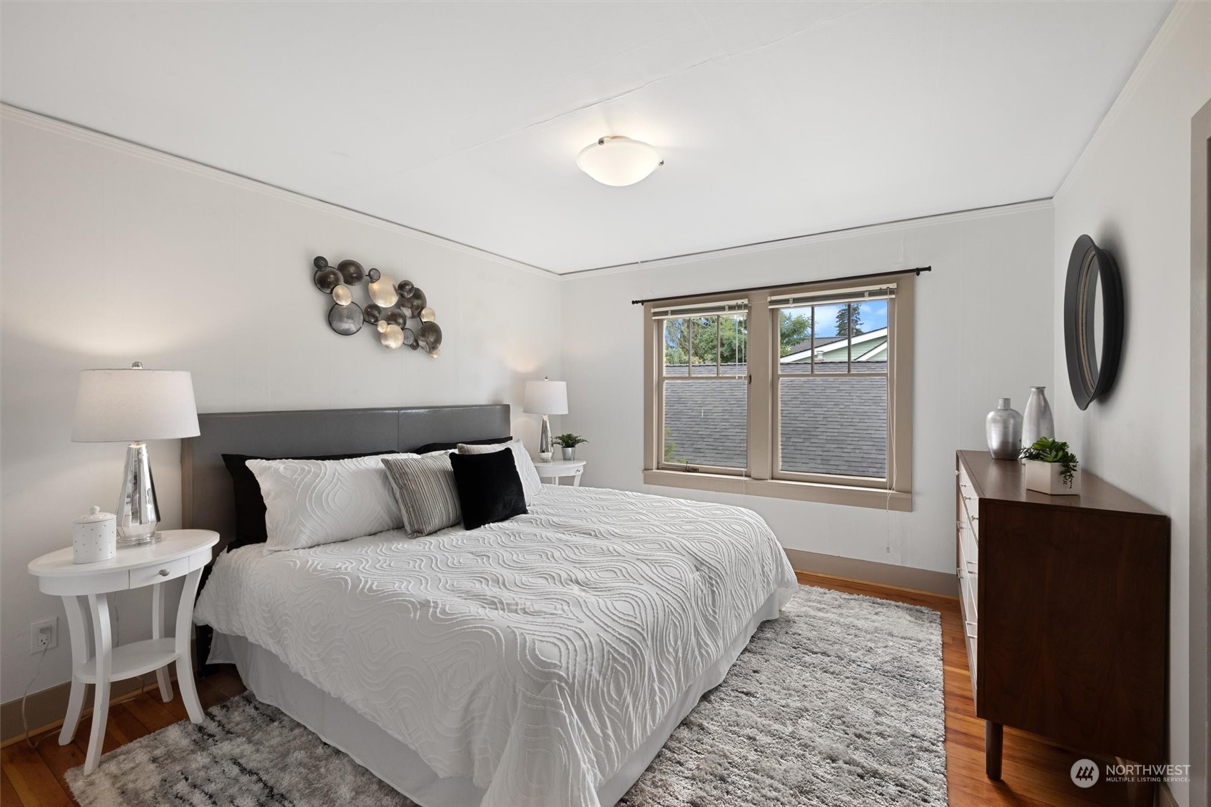 5916 8th Avenue Northeast Seattle, WA 98105 - Photo 22 of 40 a bedroom with a bed and a flat tv screen on the dresser