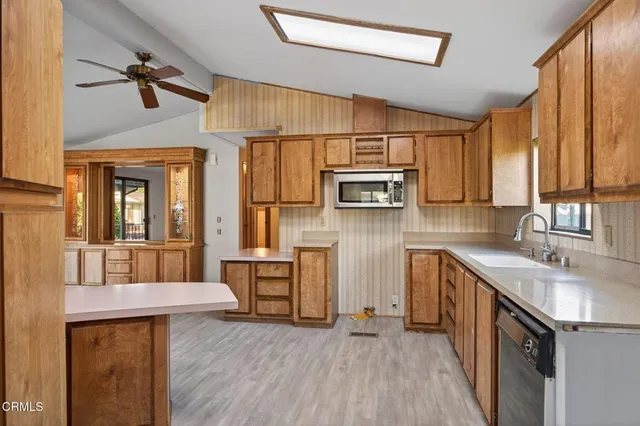 a kitchen with stainless steel appliances granite countertop a sink a microwave cabinets and a stove