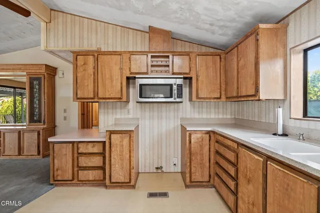 a kitchen with a sink and large window