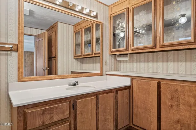 a bathroom with a granite countertop shower a toilet and a shower