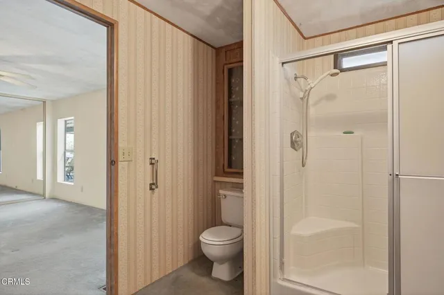 a view of an empty room with a ceiling fan