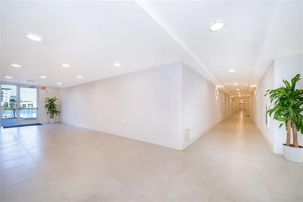 a view of a hallway with potted plants
