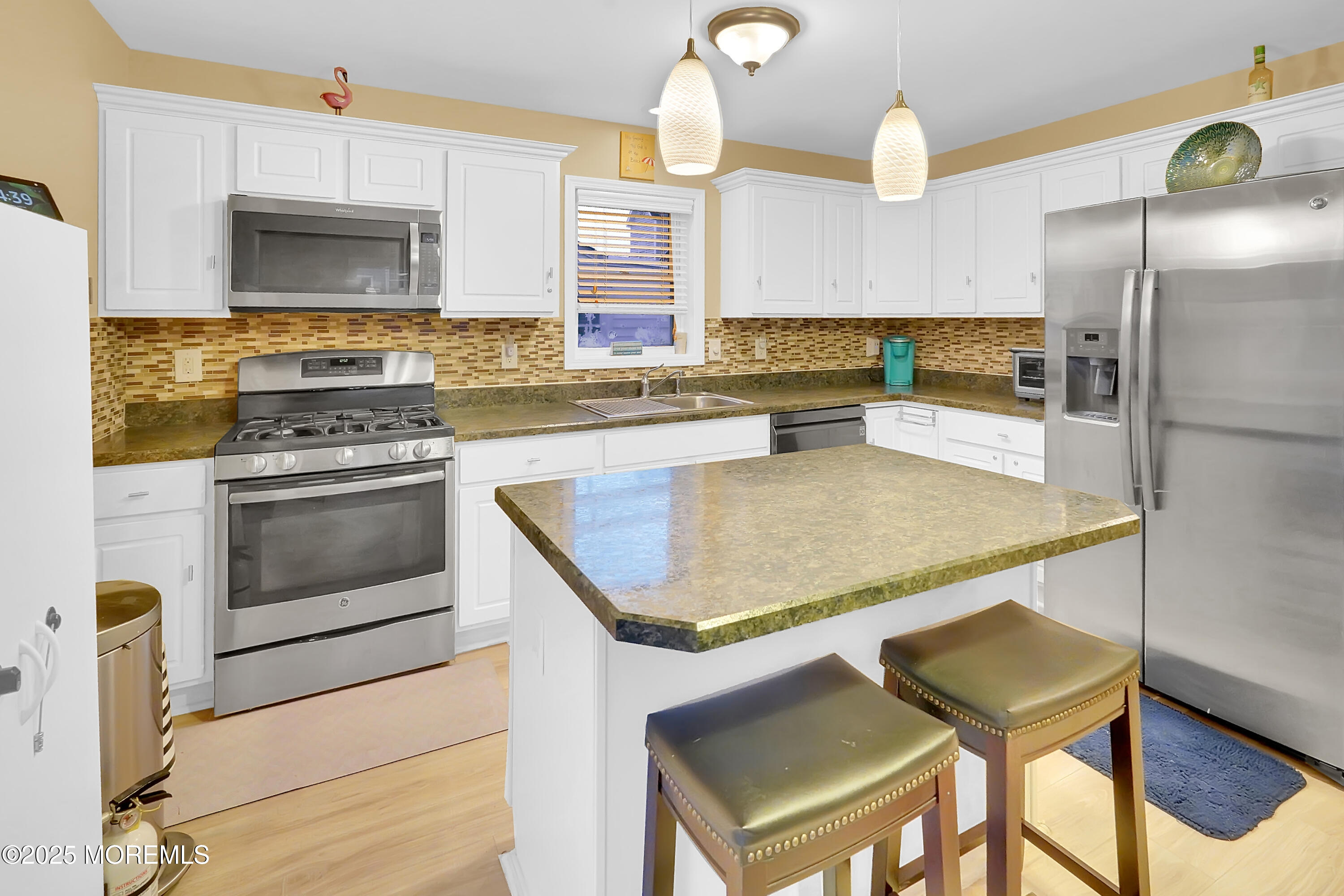 419 Coolidge Avenue Seaside Heights, NJ 08751 - Photo 73 of 82 a kitchen with kitchen island granite countertop a stove a sink island and a refrigerator