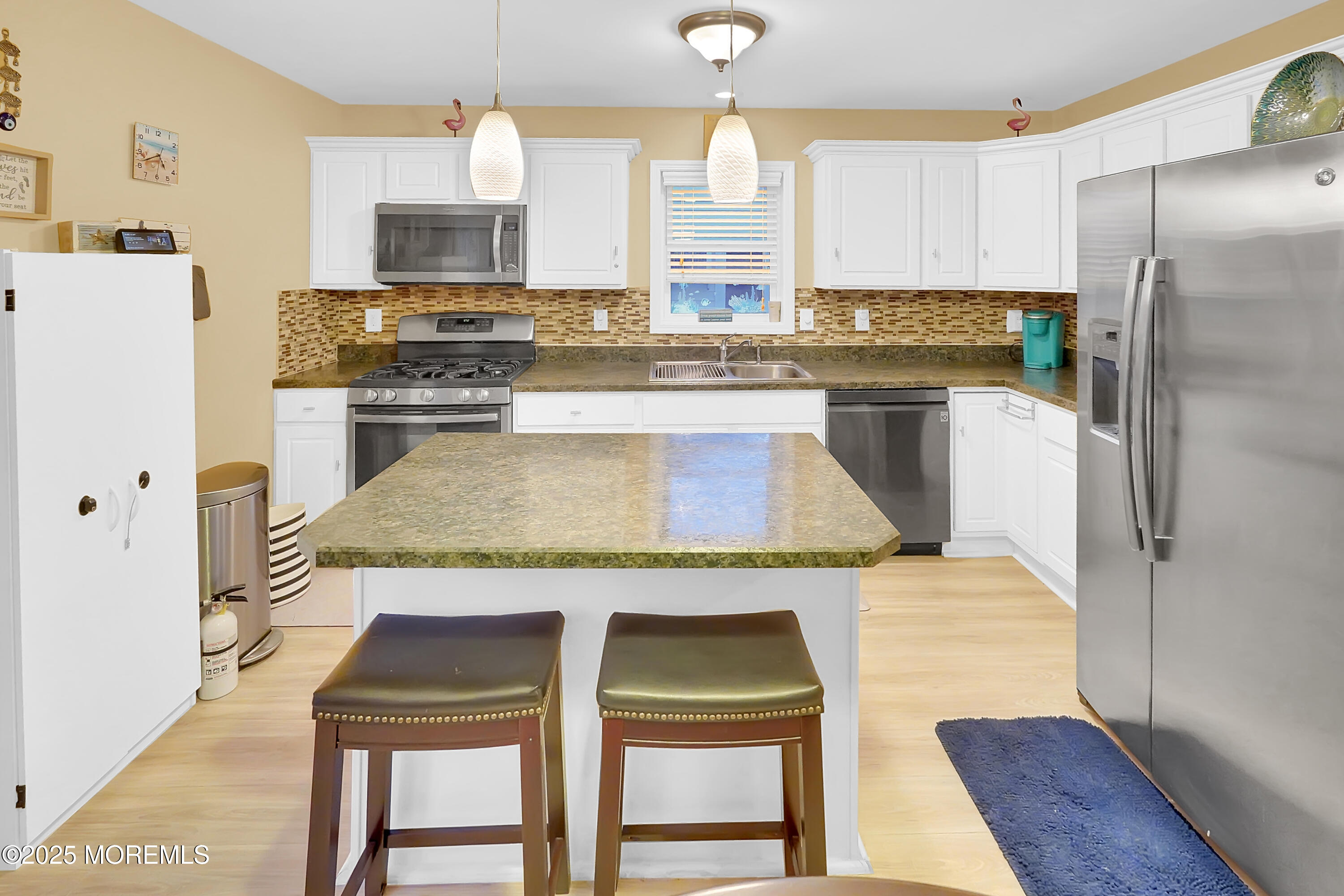 419 Coolidge Avenue Seaside Heights, NJ 08751 - Photo 74 of 82 a kitchen with stainless steel appliances granite countertop a table chairs stove and refrigerator