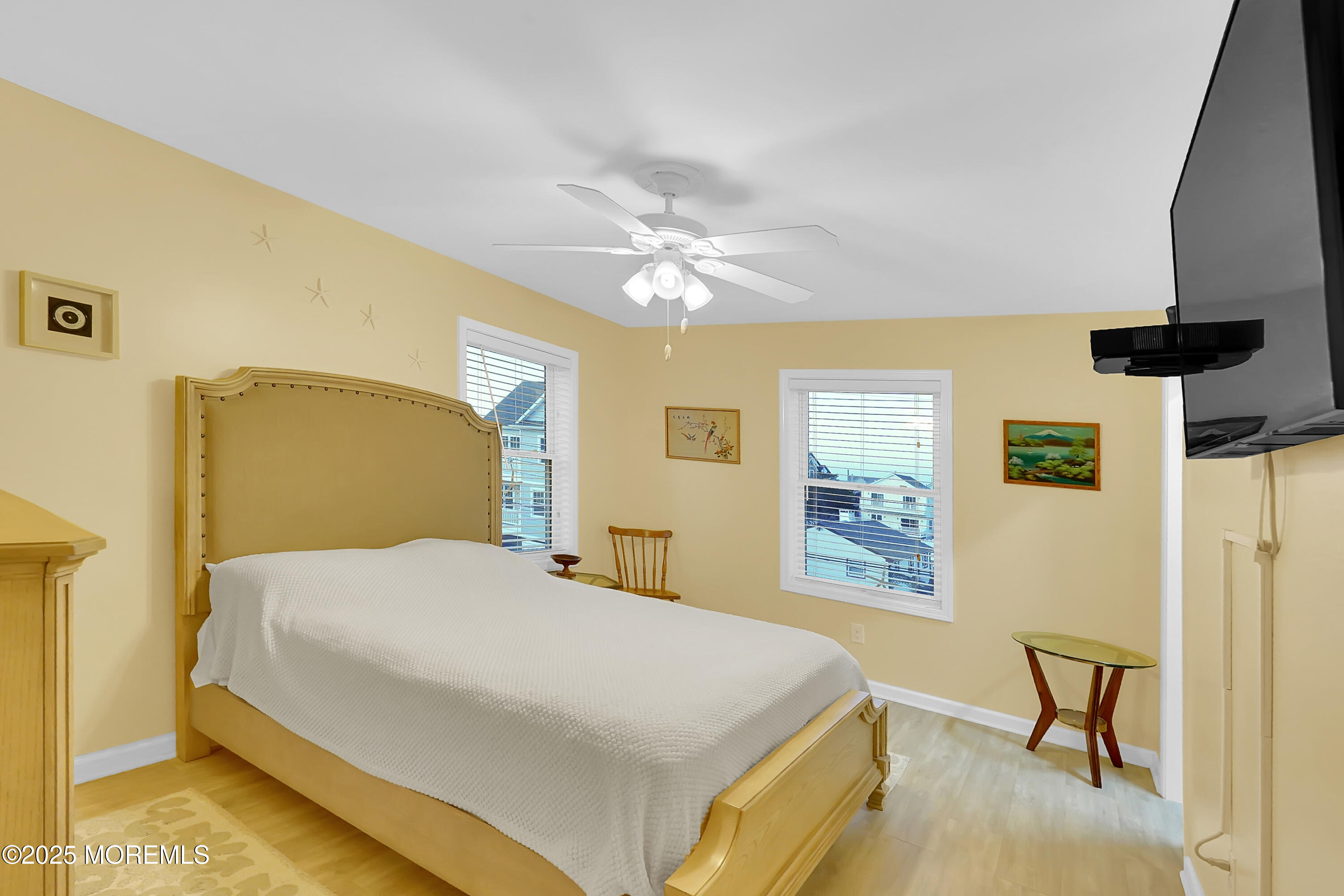 419 Coolidge Avenue Seaside Heights, NJ 08751 - Photo 8 of 82 a bedroom with a bed and a chandelier