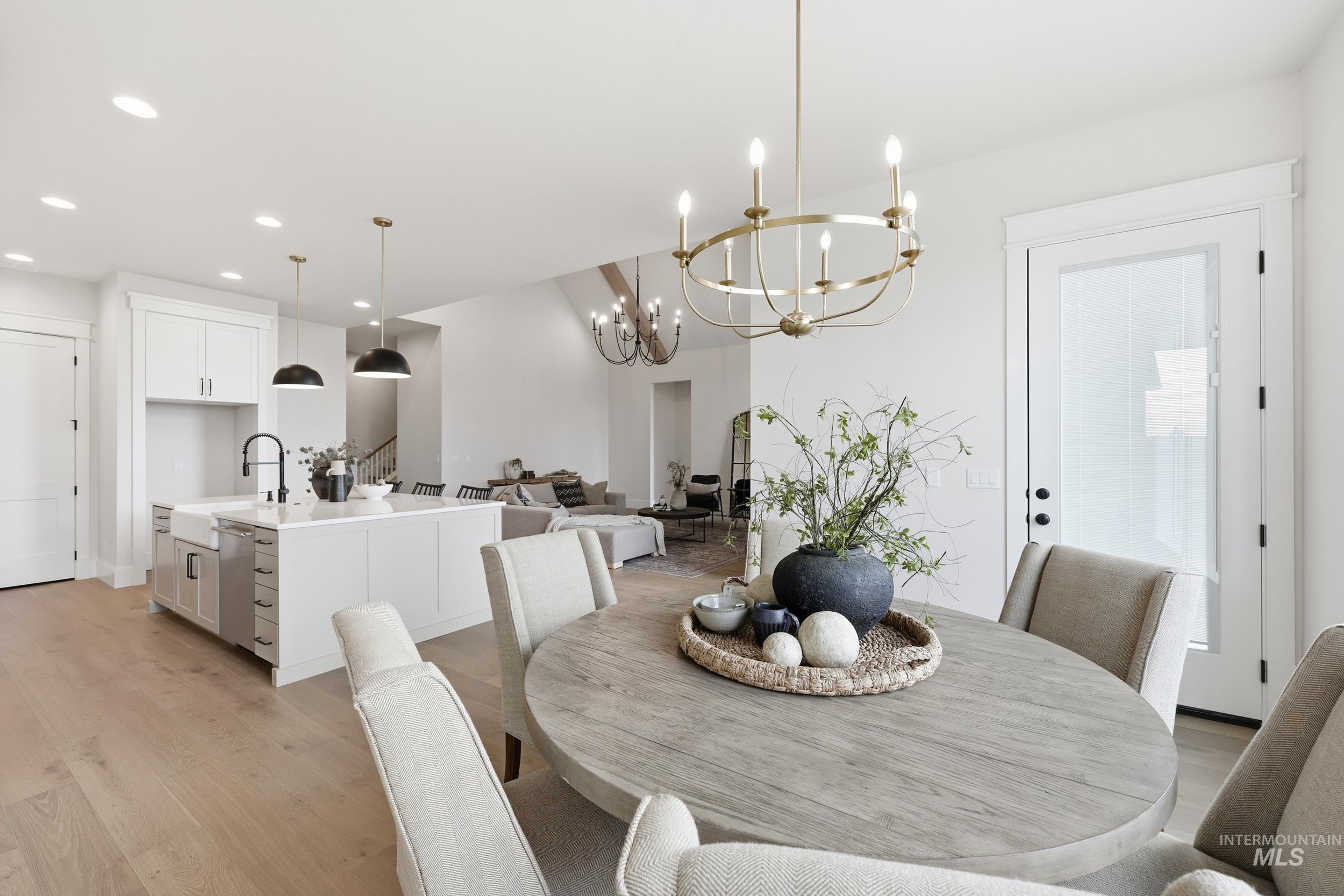 6513 South Utmost Way Meridian, ID 83642 - Photo 13 of 47 Dining space featuring recessed lighting, light wood finished floors, stairway, and a chandelier