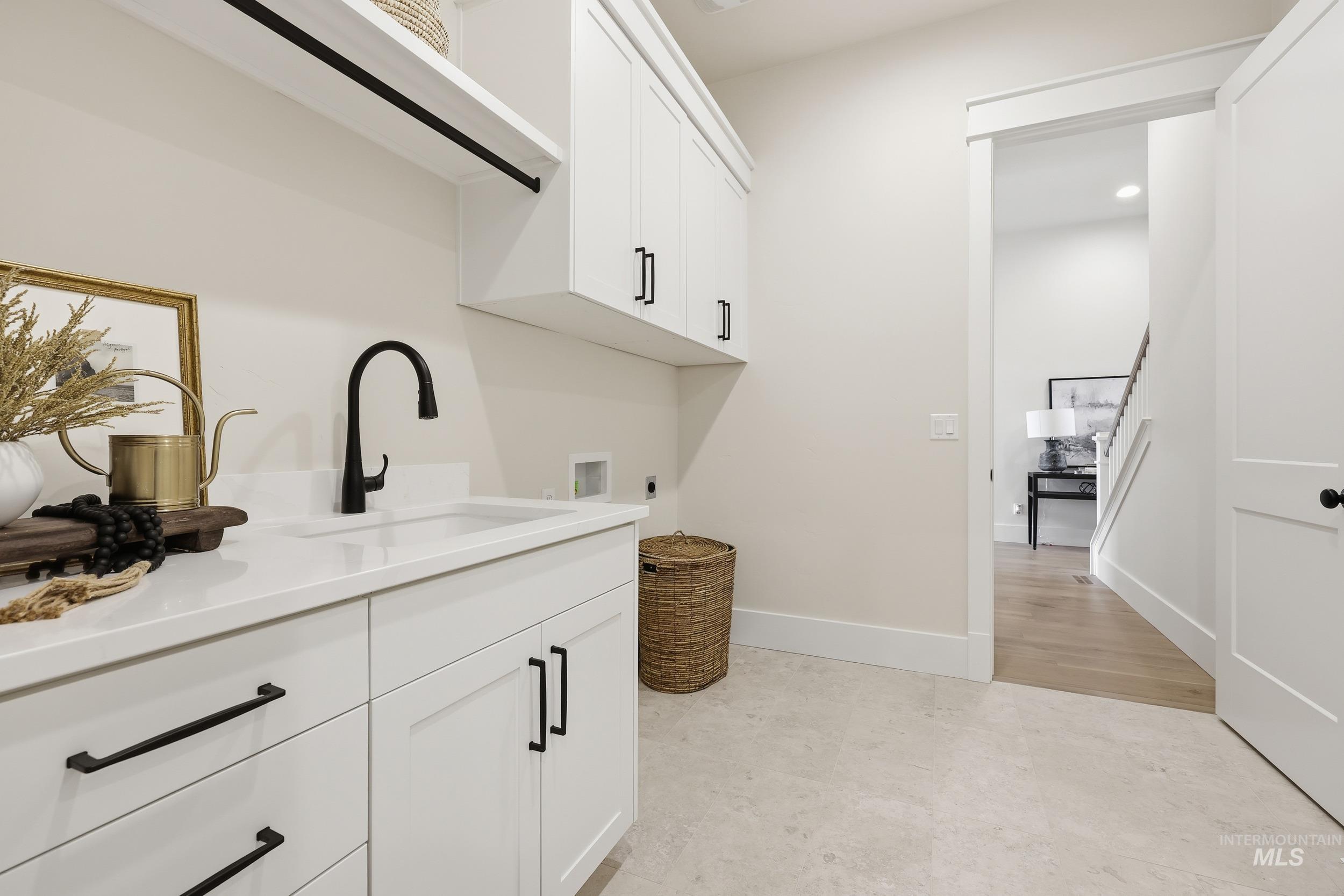 6513 South Utmost Way Meridian, ID 83642 - Photo 24 of 47 Laundry area with cabinet space, hookup for an electric dryer, washer hookup, recessed lighting, and light flooring