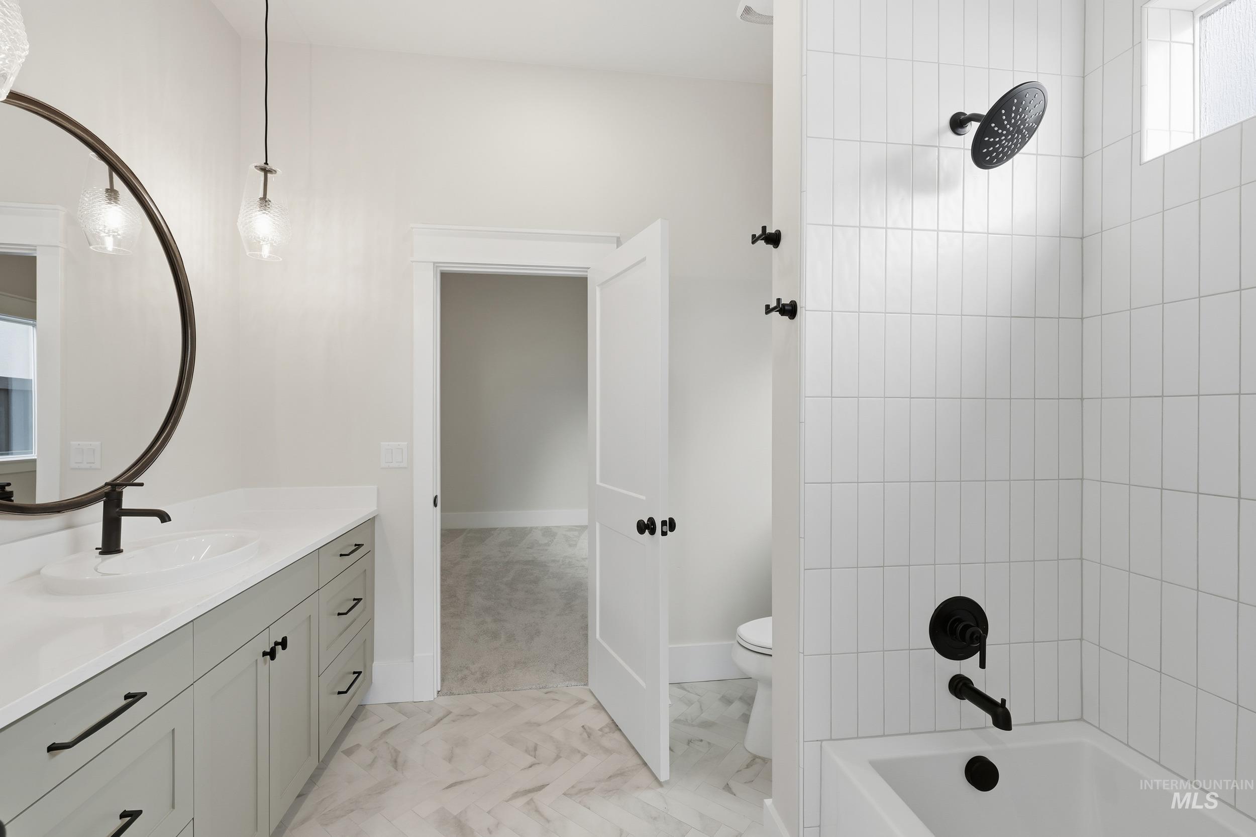 6513 South Utmost Way Meridian, ID 83642 - Photo 32 of 47 Bathroom featuring vanity, shower / bathtub combination, and light marble finish flooring