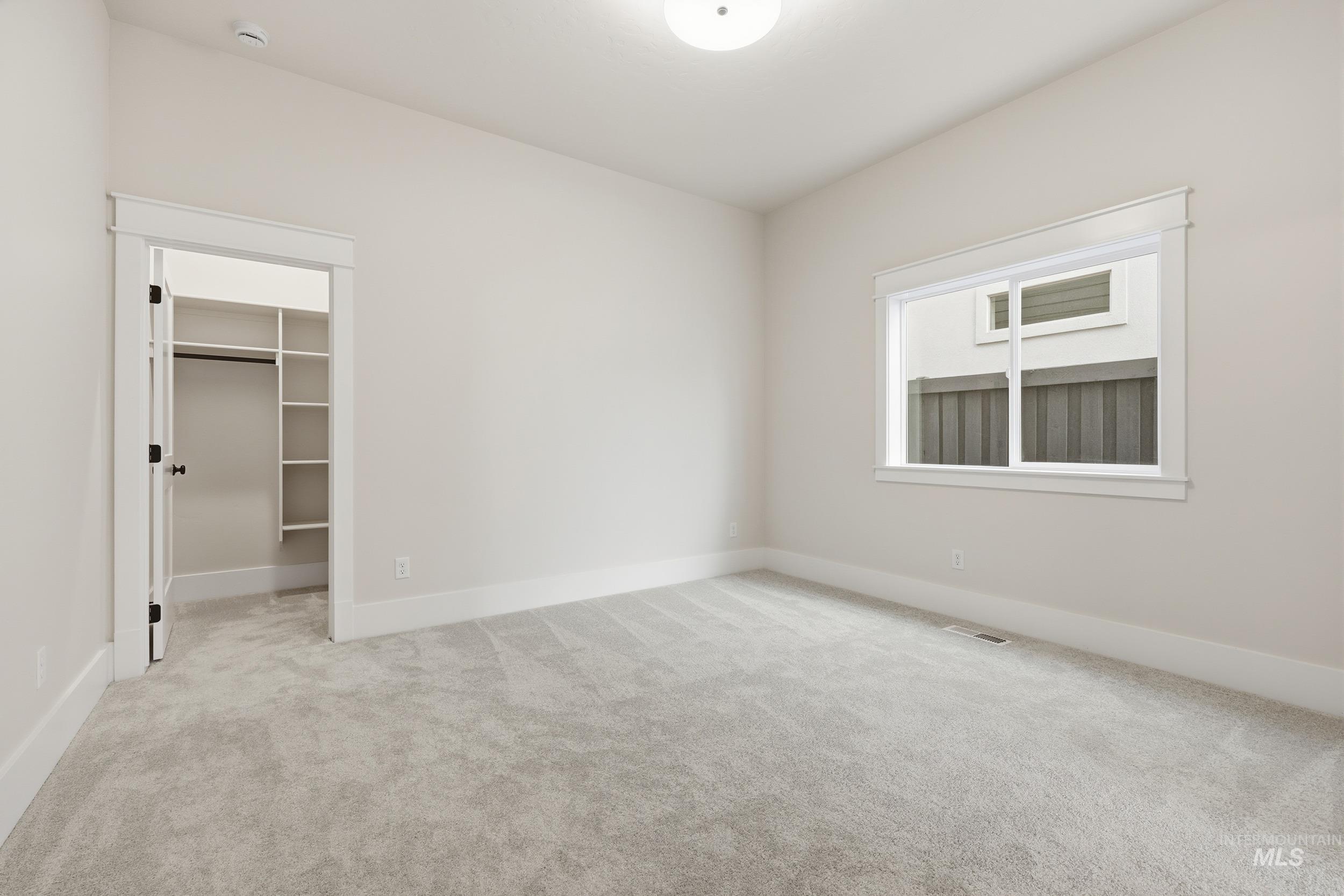 6513 South Utmost Way Meridian, ID 83642 - Photo 34 of 47 Unfurnished bedroom featuring a spacious closet and light carpet