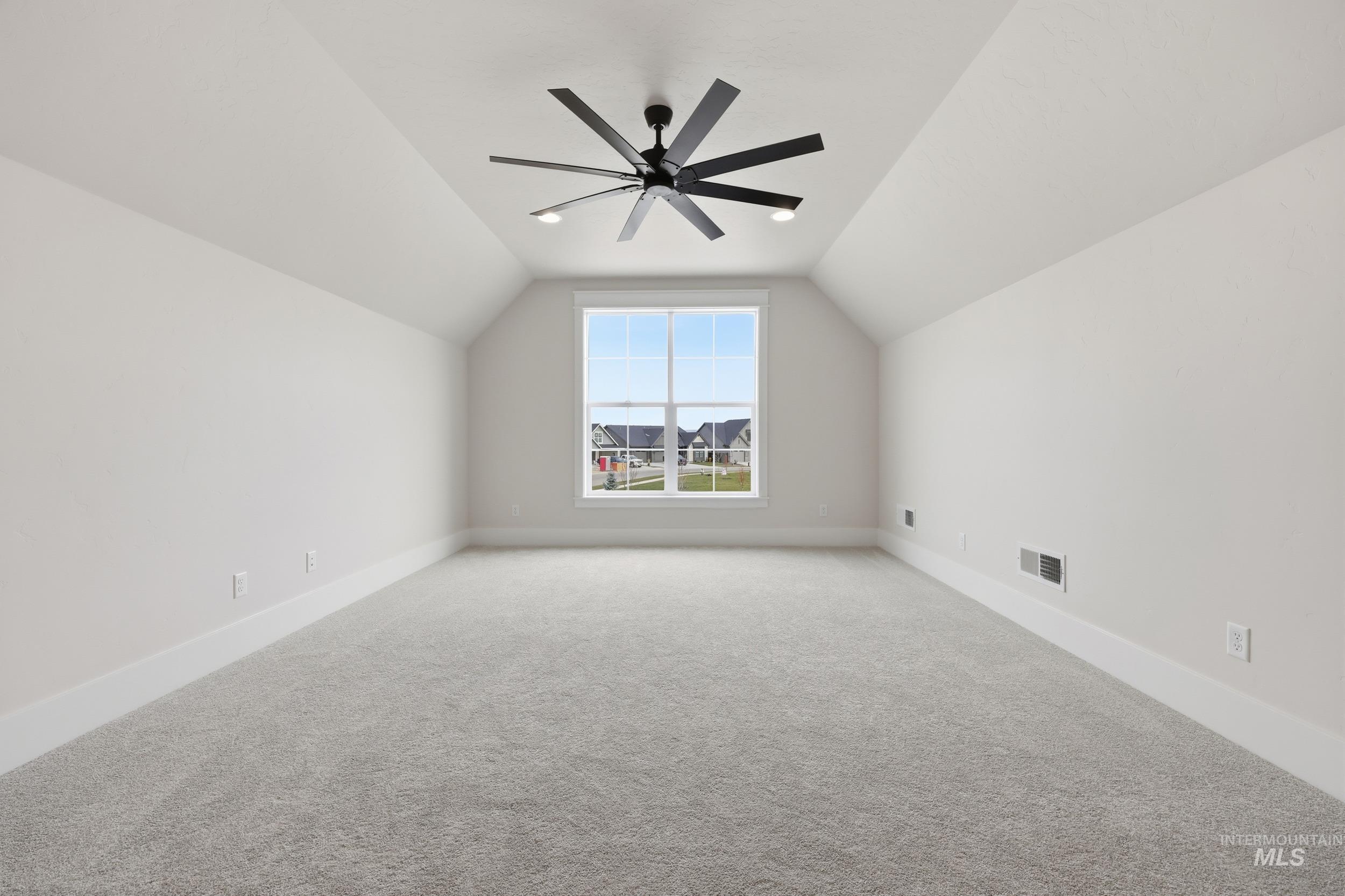 6513 South Utmost Way Meridian, ID 83642 - Photo 38 of 47 Bonus room with lofted ceiling, carpet, and a ceiling fan