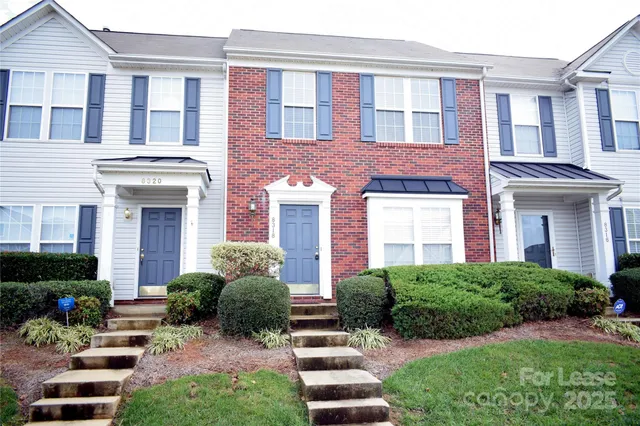 a front view of a house with a yard and outdoor seating