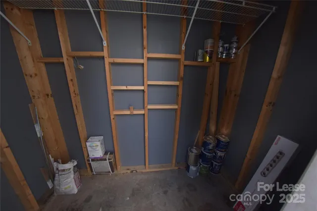 a view of an empty room with storage