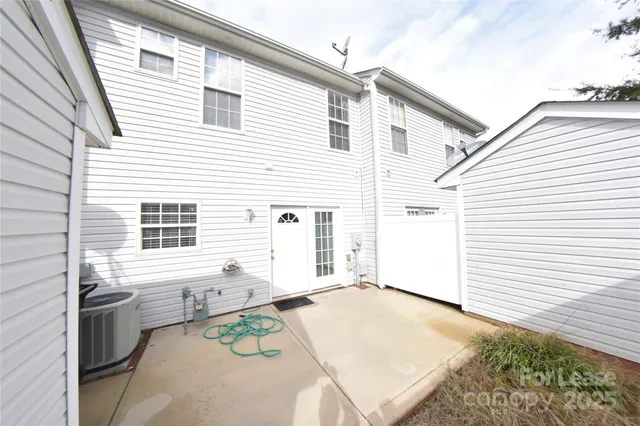 a view of a white house with many windows