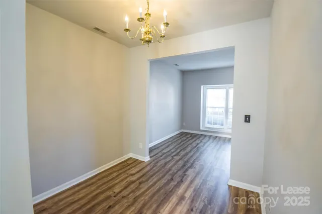 a view of a room with wooden floor and staircase