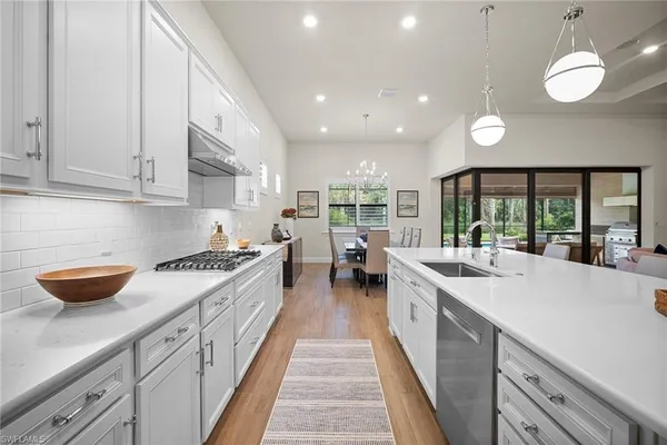 a kitchen with stainless steel appliances granite countertop lots of counter space and a sink