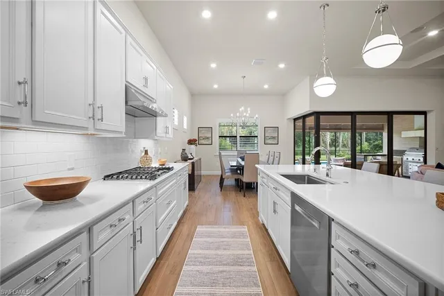 a kitchen with stainless steel appliances granite countertop lots of counter space and a sink